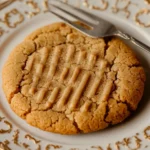 Why do they put fork marks in peanut butter cookies shows a baking sheet full of cookies,